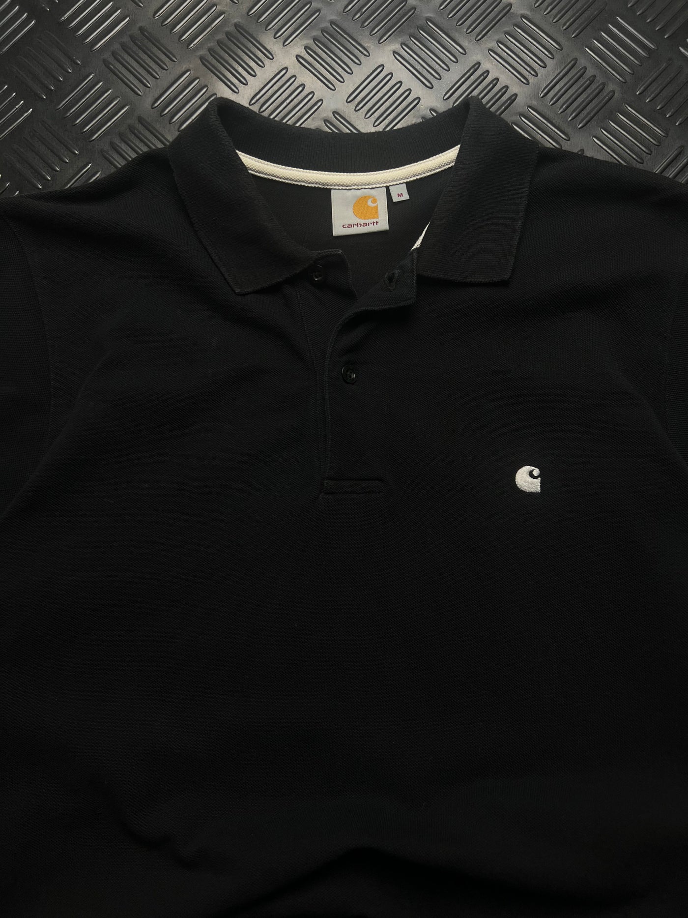 Detalle de polo carhartt negro talla m