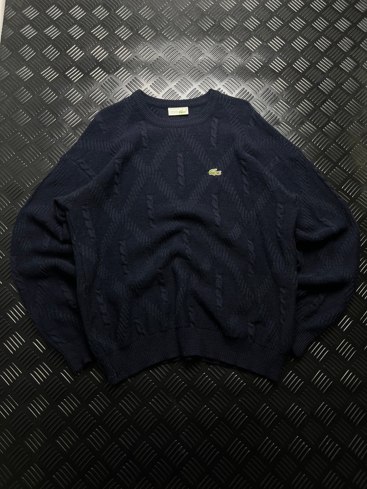 Lacoste: Jersey azul marino con detalles trenzados