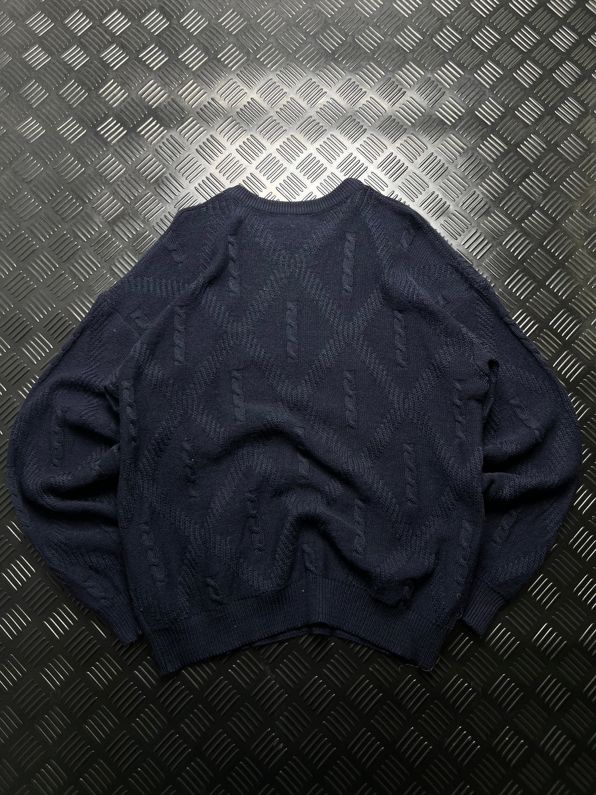 Lacoste: Jersey azul marino con detalles trenzados
